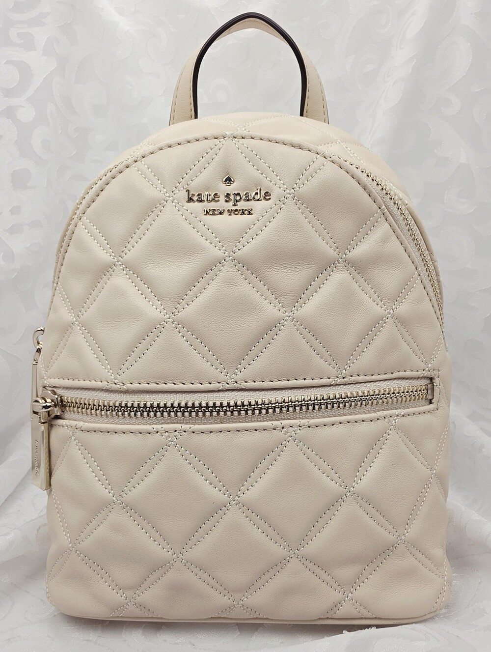 kate spade New York Quilted Cream Mini Backpack
